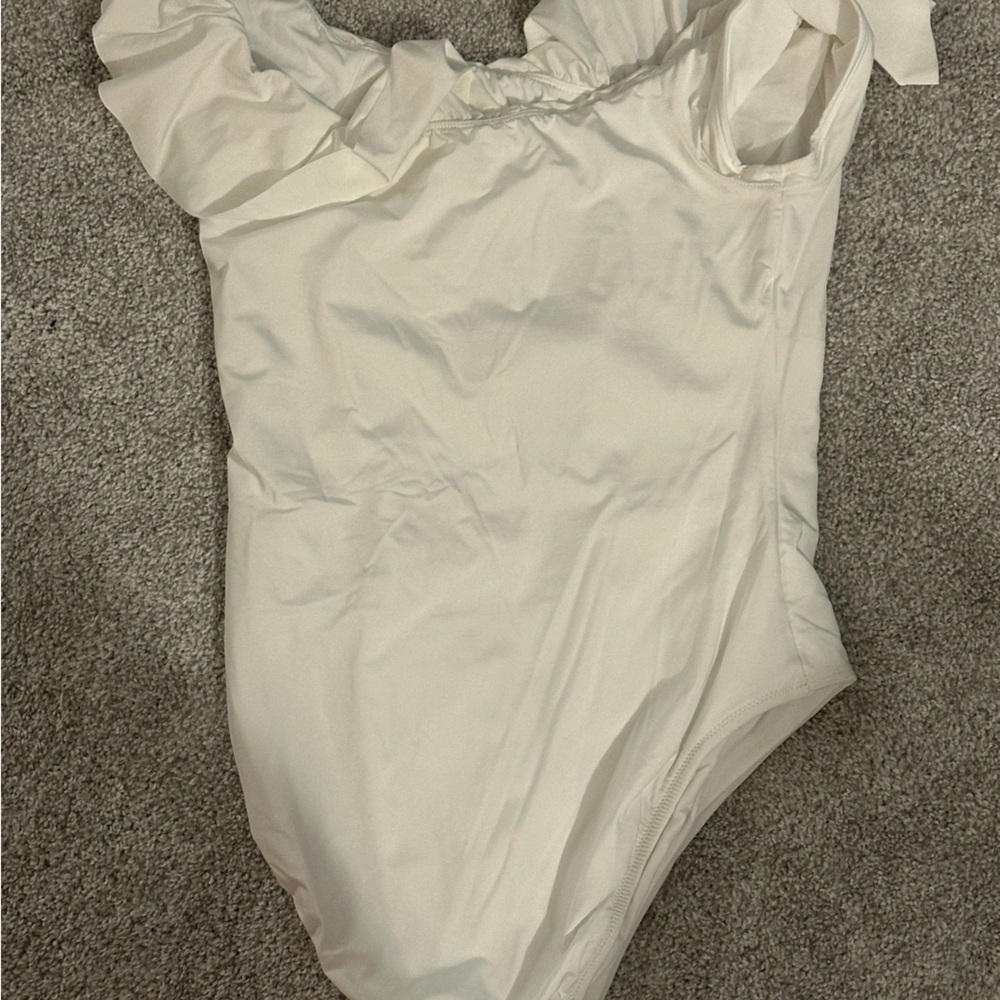 New with tags white Trina Turk ruffle one piece swimsuit.  Size 14.